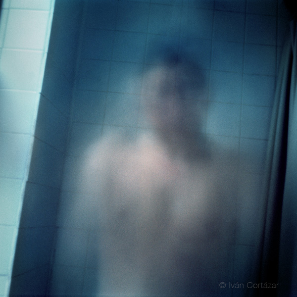 A pinhole photograph of a man taking a shower